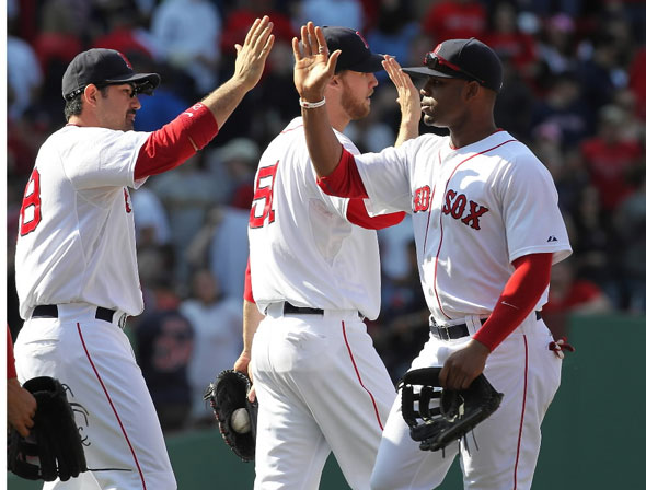 Adrian Gonzalez, Carl Crawford, and Daniel Bard of the Boston Red Sox celebrate defeating the Oakland Athletics, 6-3, at Fenway Park on June 5, 2011 in Boston, Massachusetts