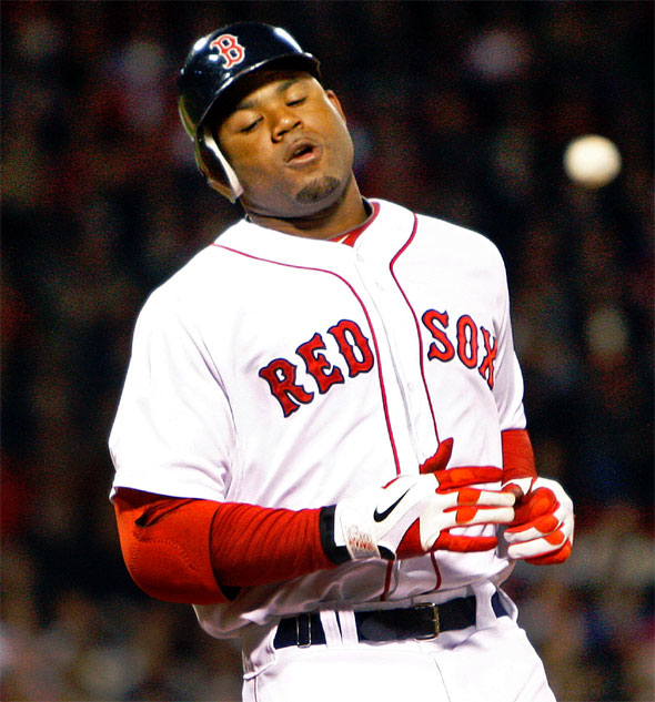 The Red Sox Carl Crawford reacts after he grounded out in the first inning. Yankees 1B Mark Teixeiratosses the ball around the infield in the backround. The Boston Red Sox hosted the New York Yankees at Fenway Park.