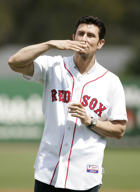 Former Boston Red Sox shortstop Nomar Garciaparra, who signed a Red Sox one-day minor league baseball contract, blows a kiss to the crowd as he takes the field to throw out a ceremonial first pitch at City of Palms Park, in Fort Myers, Fla., Wednesday, March 10, 2010. 
