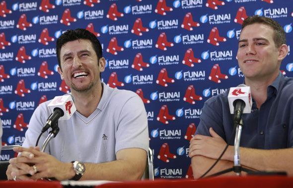 Former Boston Red Sox shortstop Nomar Garciaparra takes questions from reporters as Red Sox general manager Theo Epstein looks on during a news conference at City of Palms Park in Fort Myers, Fla., Wednesday, March 10, 2010.