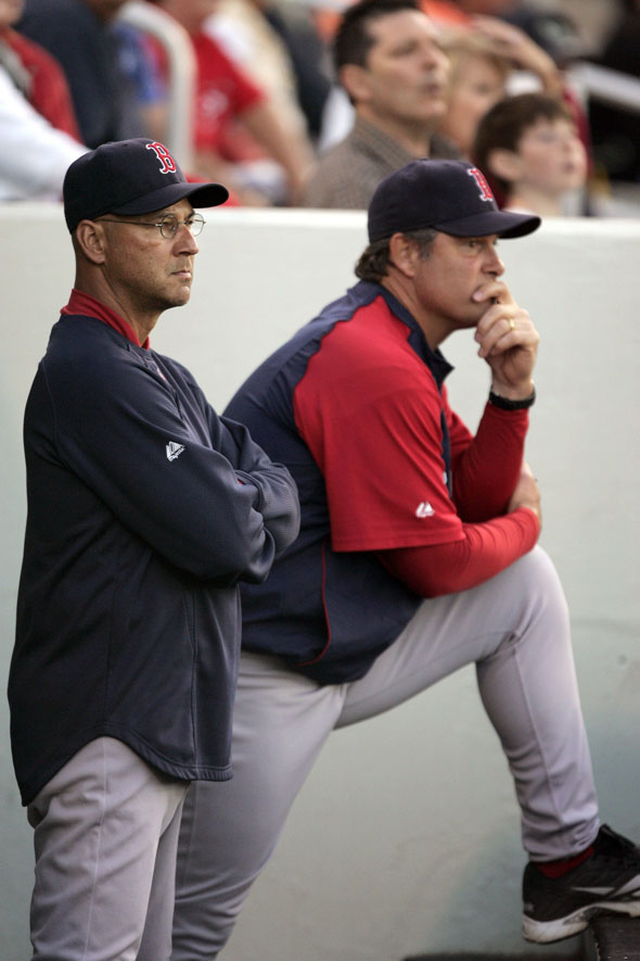 Red Sox manager Terry Francona, left, and pitching coach John Farrell, right, watch as Red Sox's Clay Buchholz pitches in the first inning of a spring training baseball game against the Minnesota Twins, in Fort Myers, Fla. Tuesday, March 23, 2010