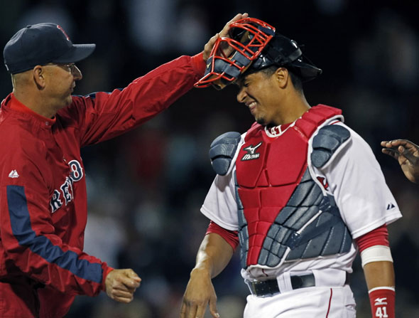 Red Sox manager Terry Francona gives catcher Victor Martinez (who is bracing fore a solid hit) a rap on the head as they celebrate the sweep of the Angels series. The Boston Red Sox take on the Los Angeles Angels of Anaheim at Fenway Park.