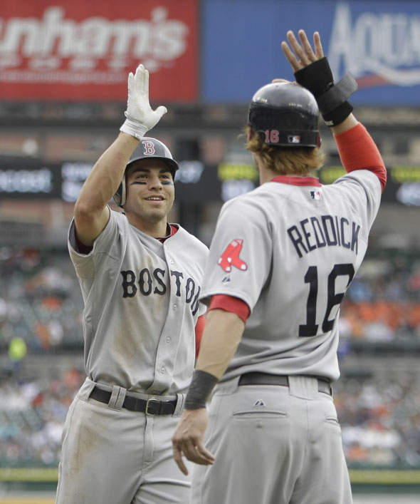 Jacoby Ellsbury is greeted at homeplate by teammate Josh Reddick after his three-run home run in the second inning of a baseball game against the Detroit Tigers in Detroit, Thursday, May 26, 2011.