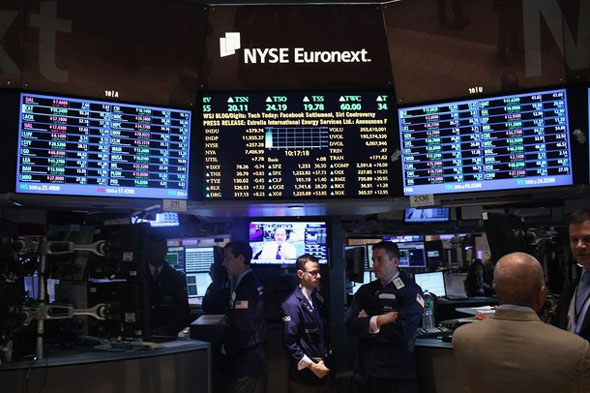 Traders work on the floor of the New York stock Exchange on November 30, 2011