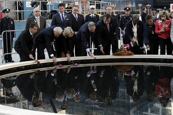 New York Governor David Patterson, US Vice President Joe Biden, Dr. Jill Biden, New York City Mayor Michael Bloomberg, New Jersey Governor Chris Christie and family members of the victims of 9/11 gather around the Ground Zero reflecting pool 