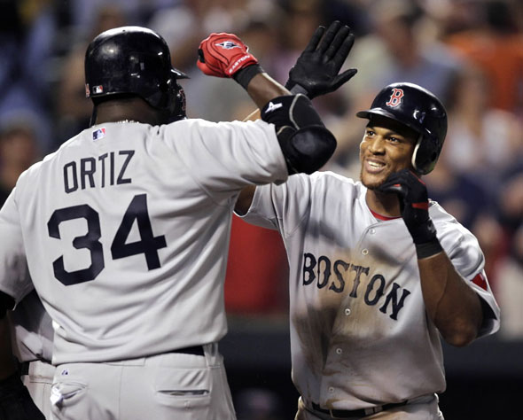Adrian Beltre, right, celebrates his three-RBI home run with teammate David Ortiz (34) during the seventh inning of a baseball game against the Baltimore Orioles, Wednesday, Sept. 1, 2010