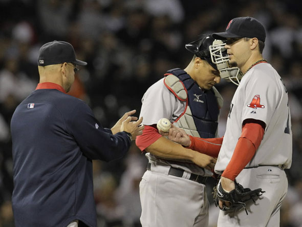 Red Sox manager Terry Francona, left, relieves starting pitcher Josh Beckett, right, as catcher Victor Martinez, looks on during the seventh inning of a baseball game against the Chicago White Sox, Wednesday, Sept. 29, 2010, in Chicago. (