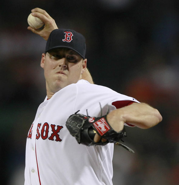 John Lackey delivers against the Baltimore Orioles during the first inning of a baseball game at Fenway Park