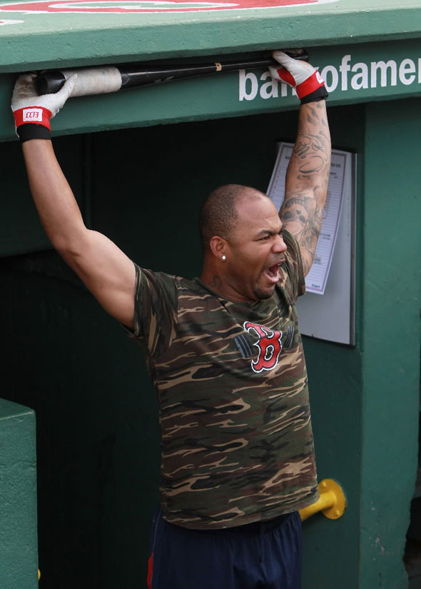Boston Red Sox left fielder Carl Crawford stretches in the dugout before the game. The Boston Red Sox took on the Baltimore Orioles in Game 3 of a 4 game series at Fenway Park