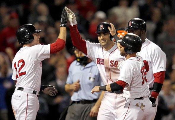 Conor Jackson Red Sox celebrates his grand slam with Jed Lowrie of the Boston Red Sox, Dustin Pedroia of the Boston Red Sox, and David Ortiz of the Boston Red Sox during the second game of a doubleheader with the Baltimore Orioles at Fenway Park September 19, 2011 in Boston, Massachusetts.